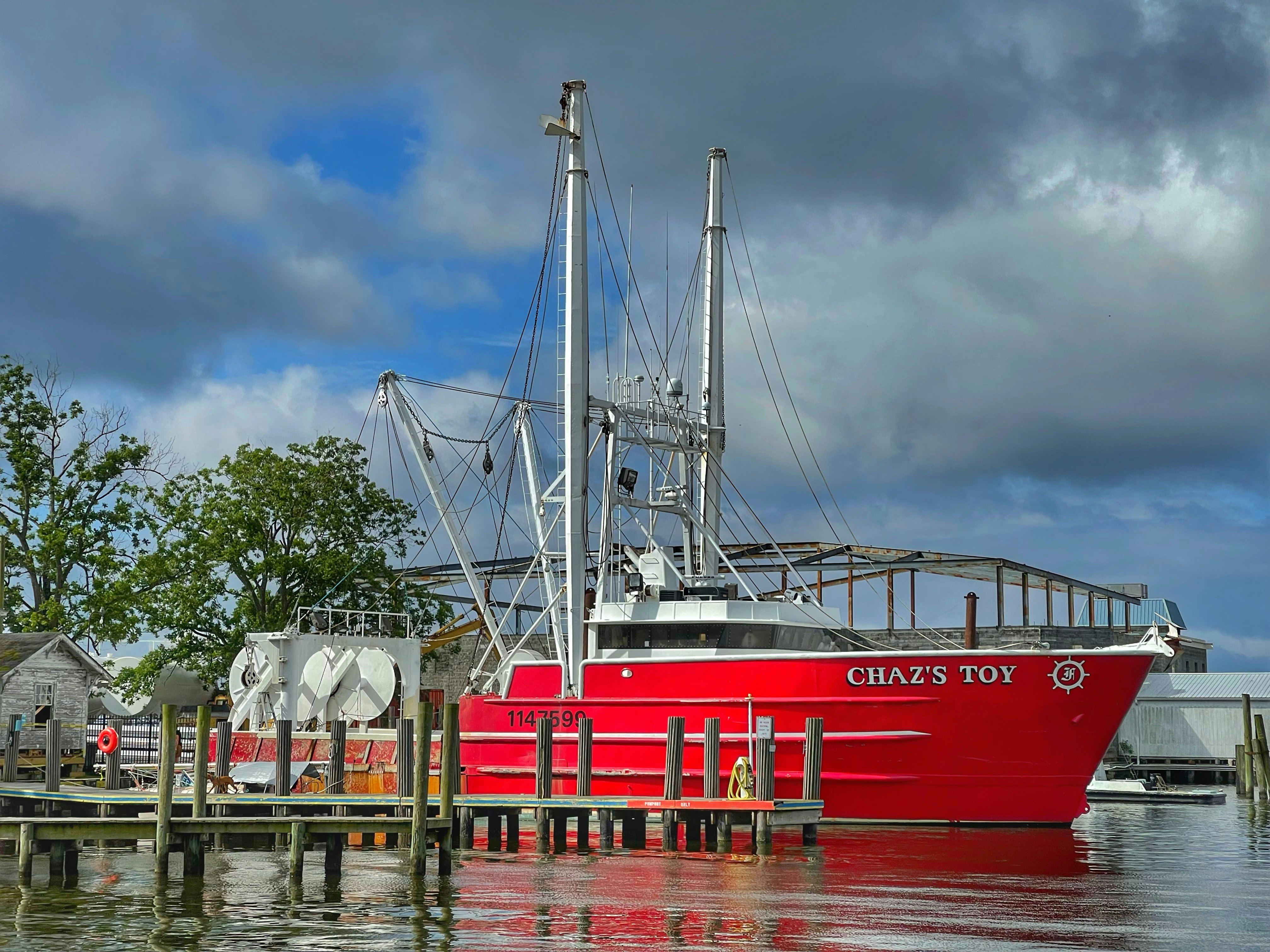 red and white boat on water during daytime